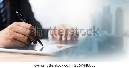 Electronic signature concept, Paperless office concept. Businessman uses a pen to sign electronic documents on digital documents,E-signing.Technology and document management,Business contract signing.