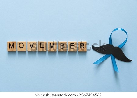 Movember concept - event to raise awareness of men's health issues, moustache anf blue ribbon