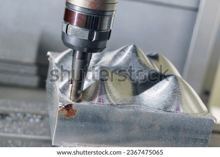 The CNC milling machine rough cutting the injection mold parts by indexable tools. The mold and die manufacturing process by machining center with the solid endmill tools. Royalty-Free Stock Photo #2367475065