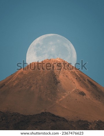 full moon crowning the crater of the teide volcano Royalty-Free Stock Photo #2367476623