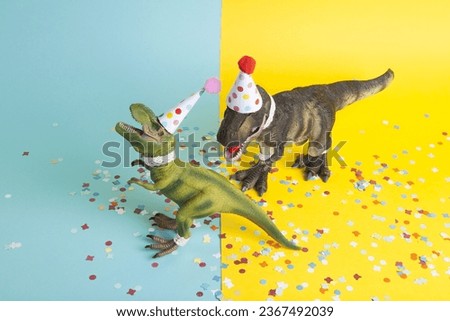 pair of dinosaurs celebrating on a confetti carpet, dressed in lace and a paper party hat, at a birthday party against a yellow and blue background. Minimal creative still life colourful photography 