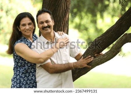 Indian happy mature loving couple spending time and enjoying at park. Concept :Mature Couple Lifestyle