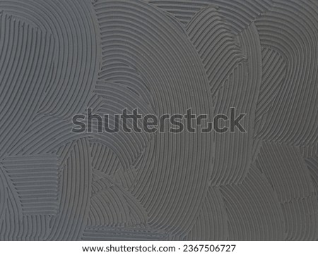 Cement wall cementitious adhesive applied to the floor.Modern gray background with curved lines
 Royalty-Free Stock Photo #2367506727