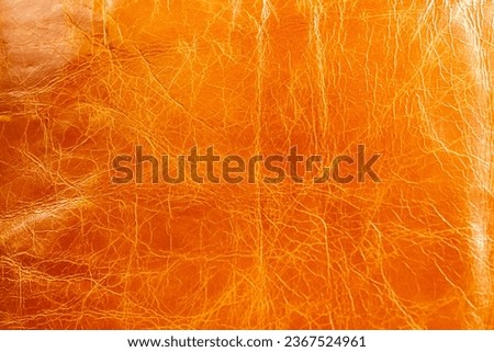 Crazed leather texture in burned orange colour as a background  Royalty-Free Stock Photo #2367524961