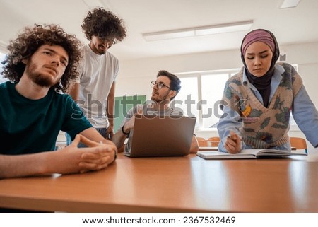 A group of diverse college students studying together or working on a school project.
