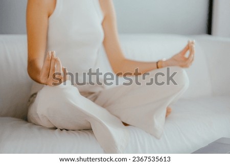 Woman meditating on a couch. Inner peace concept. Royalty-Free Stock Photo #2367535613
