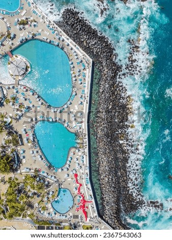 From a bird's eye view. Aerial view of Puerto de la Cruz. View from a flying drone on Lago Martianez beach. View from above. Recreation Park and Lake Martianes includes several islands, gardens