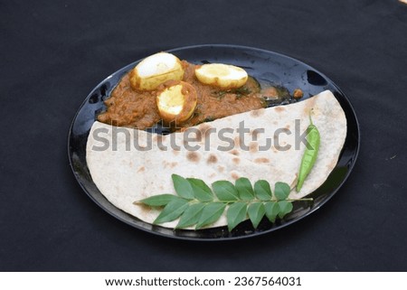 tasty chapathi chapati with egg masala gravy black plate background