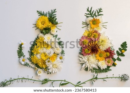cat made from vivid autumnal leaves and flowers, isolated on white background