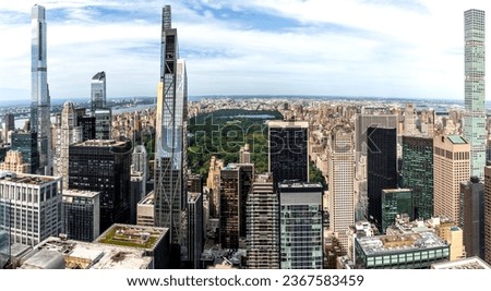 An aerial panoramic view of the buildings and skyscrapers surrounding Central Park in Midtown Manhattan from the Top of the Rock observation deck