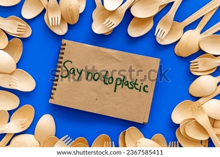 Eco friendly wooden cutlery with Say no to plastic sign. Zero waste concept.