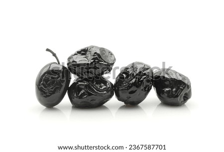 Dried black olives in oil isolated on white background                              