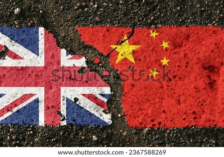 On the pavement, the images of the flags of the UK and China, as a symbol of confrontation. Conceptual image.