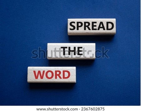 Spread the Word symbol. Concept wordsSpread the Word on wooden blocks. Beautiful deep blue background. Business and Spread the Word concept. Copy space.
