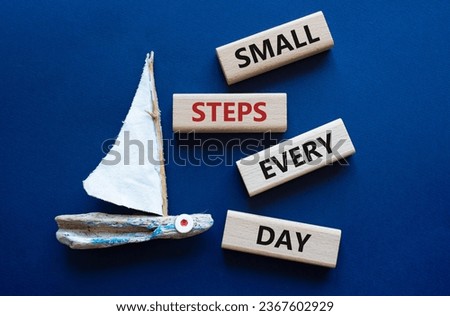 Small Steps Every Day symbol. Wooden blocks with words Small Steps Every Day. Beautiful deep blue background with boat. Business and Small Steps Every Day concept. Copy space.