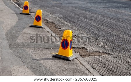 No parking signs on pavement for road resurfacing