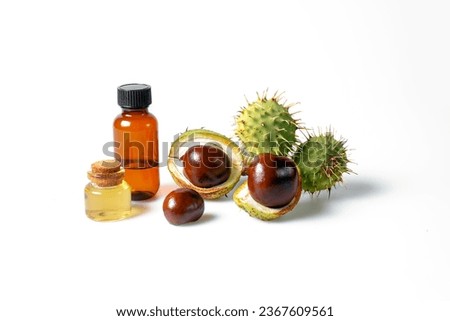 Autumn horse chestnut with peel, bottles with oil and chestnut extract on a white background Royalty-Free Stock Photo #2367609561
