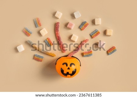 Halloween Jelly Beans Top View. Happy Halloween Party Border Beige Background. Aesthetic Accessories Banner. Spooky Orange Pumpkin Candy Bucket. Modern Holiday Design. Thanksgiving Trendy Fall Poster