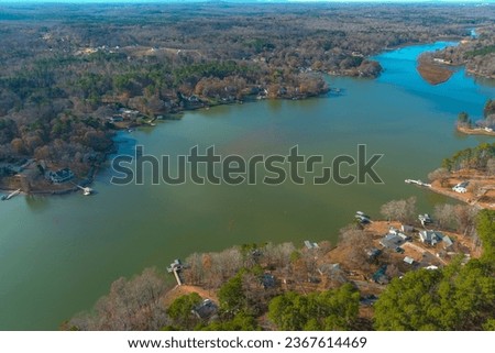 a stunning aerial shot of the Catawba River surrounded by vast miles of green and autumn colored trees in Charlotte North Carolina USA	