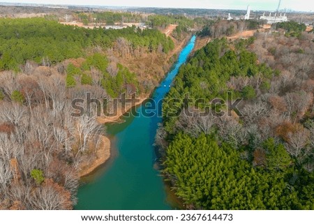 a stunning aerial shot of the Catawba River surrounded by vast miles of green and autumn colored trees in Charlotte North Carolina USA	 Royalty-Free Stock Photo #2367614473