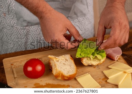 male hands preparing a burger at home