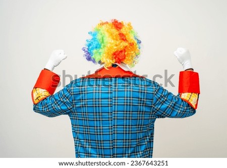 Rear view Mr Clown. Back behind Portrait of Funny comedian face Clown man in colorful uniform wearing wig standing. Happy expression male bozo in various pose on isolated background. Royalty-Free Stock Photo #2367643251