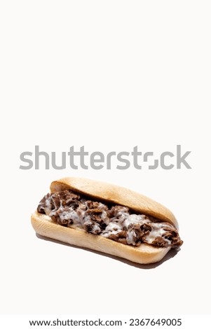 Whole philly cheese steak with melting cheese on a white background with message area at top of frame Royalty-Free Stock Photo #2367649005