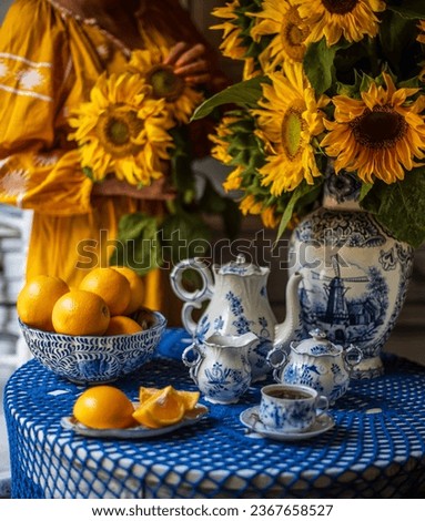 still life with sunflowers and orange. Blue and yellow colors. Delft blue. beautiful picture. autumn still life.