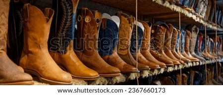 panoramic view of many cowboy boots in a shop with selective focus