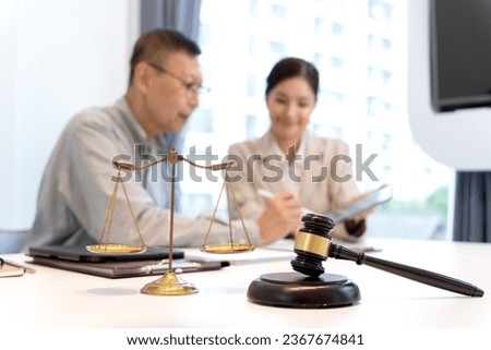 client is reading and studying the legal documents that the lawyer has presented that meet the objectives and help with business law. If they are correct he is ready to sign and agree.