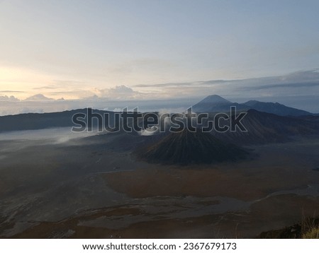 Picture of Bromo mountains view in the morning with sand desert and smoke from active crater