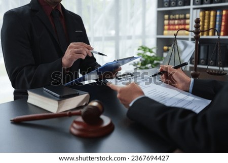 A lawyer or legal advisor is reading the statute of limitations. Clarifying details of legal contracts before signing. Consultation between lawyers and business clients. Legal services company. Royalty-Free Stock Photo #2367694427