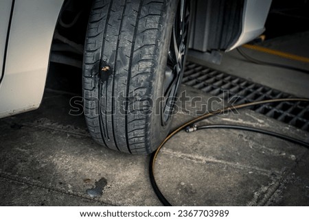 Tire repair kit for flat car tires and a tire plug repair kit for tubeless tires at the car repair shop. Royalty-Free Stock Photo #2367703989