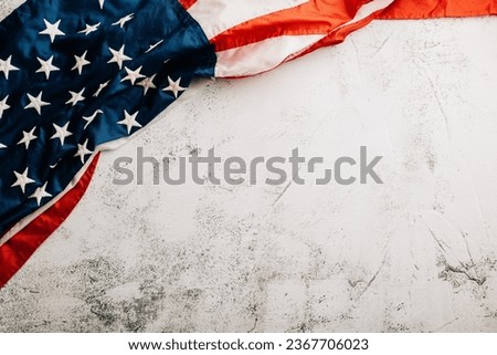 Celebrate Veteran's Day with a vintage US flag, representing American honor, pride, and unity. Patriotic stars and stripes convey the importance of government. isolated on cement background