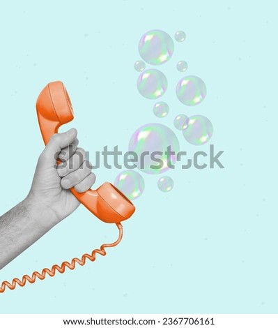 Creative modern art collage of a hand holding a retro phone and soap bubbles. Modern design. Copy space.
