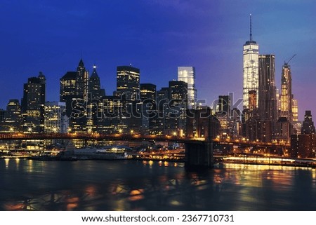 New York City Manhattan midtown at dusk with Brooklyn Bridge. USA.