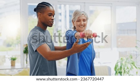 Elderly woman, dumbbells and rehabilitation therapist for exercise in a nursing home. Happy senior patient with physiotherapist man or nurse for healing, health and physiotherapy for muscle and body Royalty-Free Stock Photo #2367720447