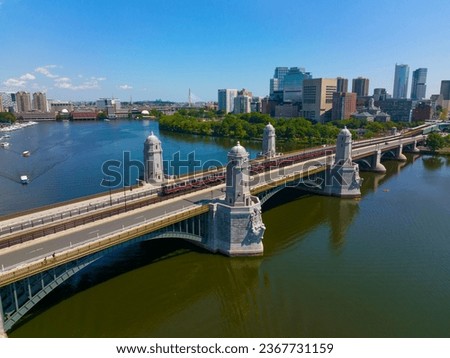Subway train on Longfellow Bridge cross over Charles River, with Boston financial district modern city skyline at the back, in downtown Boston, Massachusetts MA, USA. 