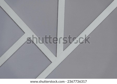 Close-up view of grey wall with white line decorations. Abstract textured background. Soft focus. Copy space for your text.