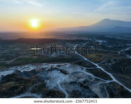 Beautiful Sunrise aerial view of Limestone mining area with a mountain as background. Aerial View of Road Leading to limestone mining area and with Lush Green Forest in Background. A beautiful aerial 