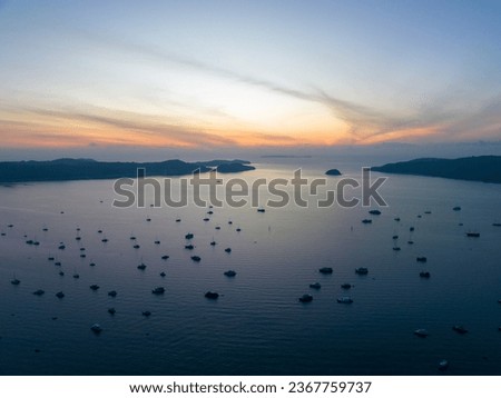 Aerial landscape Seascape Chalong pier with sailboats Yacht boats and Travel boats in the sea, Amazing sunset or sunrise sky over sea, Drone flying shot,Top down view Royalty-Free Stock Photo #2367759737