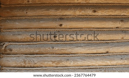 surface made of a solid log with a beautiful texture interlaced with twisted twine, graphic log resource with rope lines in country style