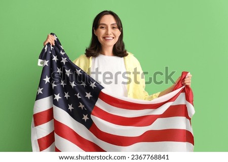 Young woman with USA flag on green background. Veterans Day celebration