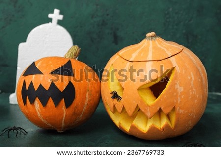 Pumpkins for Halloween celebration on green background, closeup