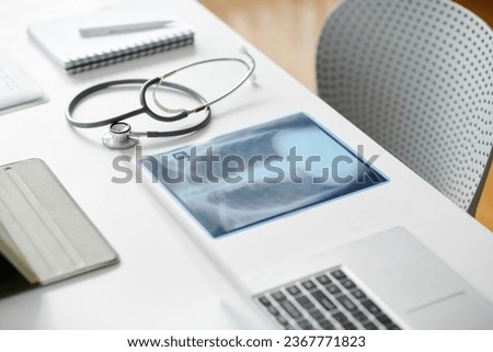 Chest x-ray image and stethoscope on desk of general practitioner Royalty-Free Stock Photo #2367771823
