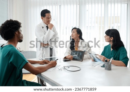 Group of medical workers gathered to discuss difficult case Royalty-Free Stock Photo #2367771859