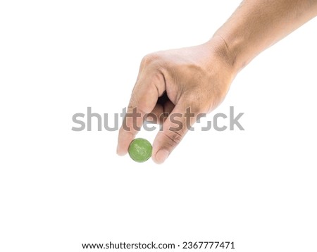 A man's hand holds a coin in his hand and is about to put the coin into something. Isolated on white background. business idea.