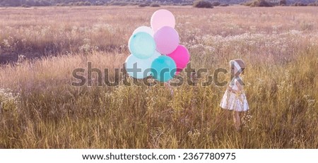 little girl in white dress with balloons outdoor