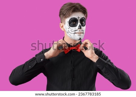 Young man dressed for Halloween on color background