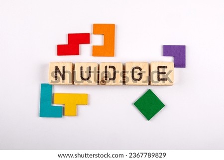 NUDGE. Wooden alphabet letters and colorful figures on a white background. Royalty-Free Stock Photo #2367789829